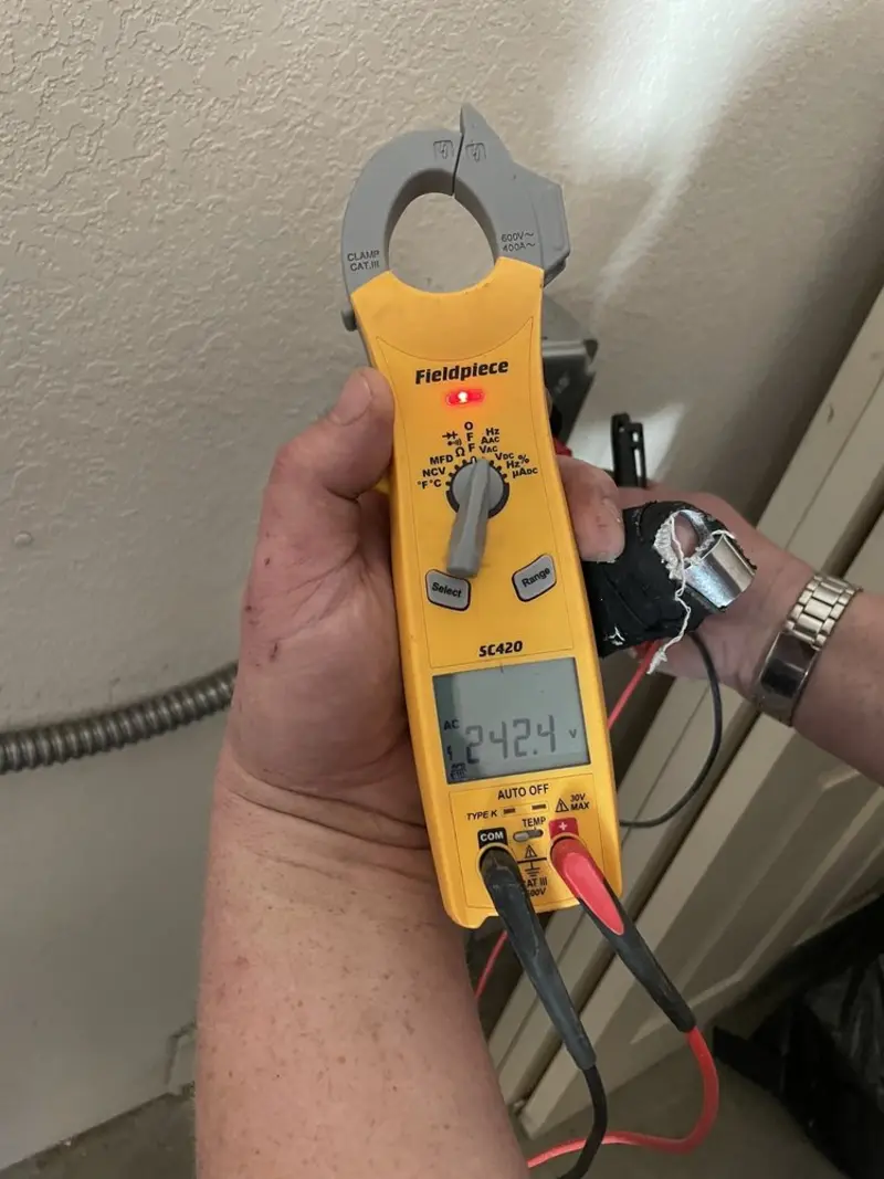 Voltage testing with clamp meter during Outlet Installation in Woodfin